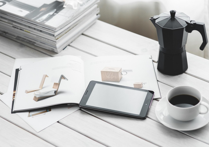 reading magazine tablet couch